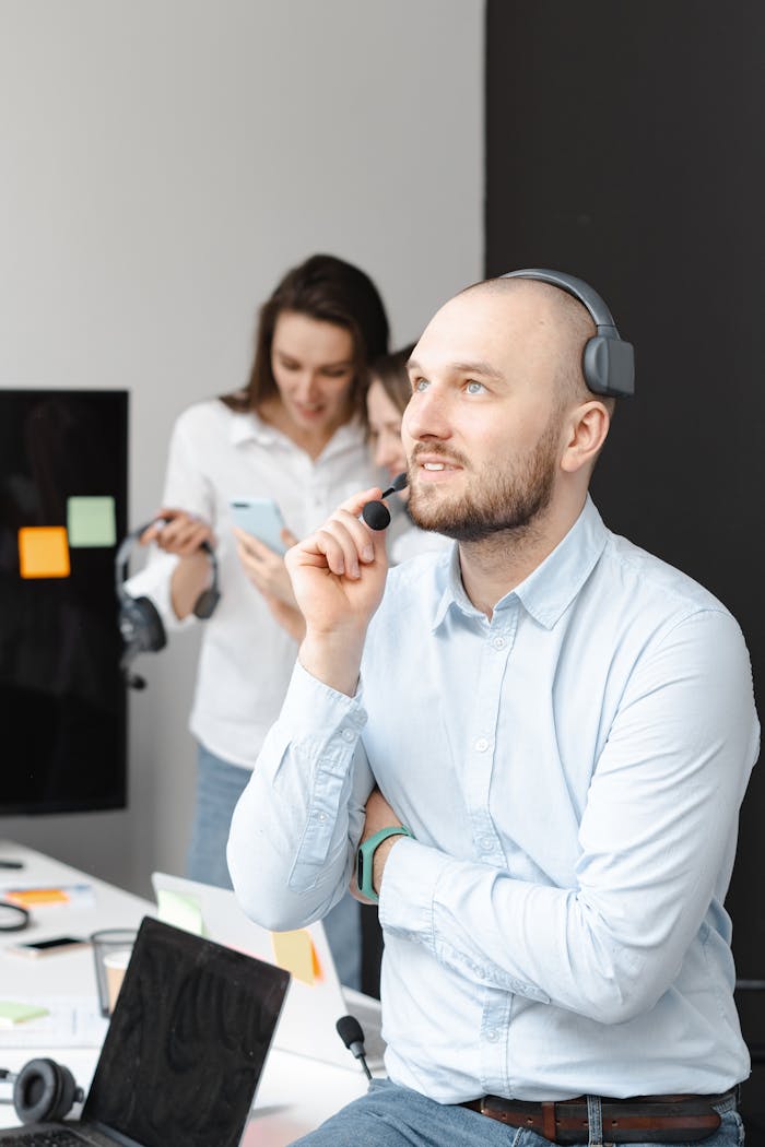 why-choose-us Man with headset working in a modern office, representing customer support services.