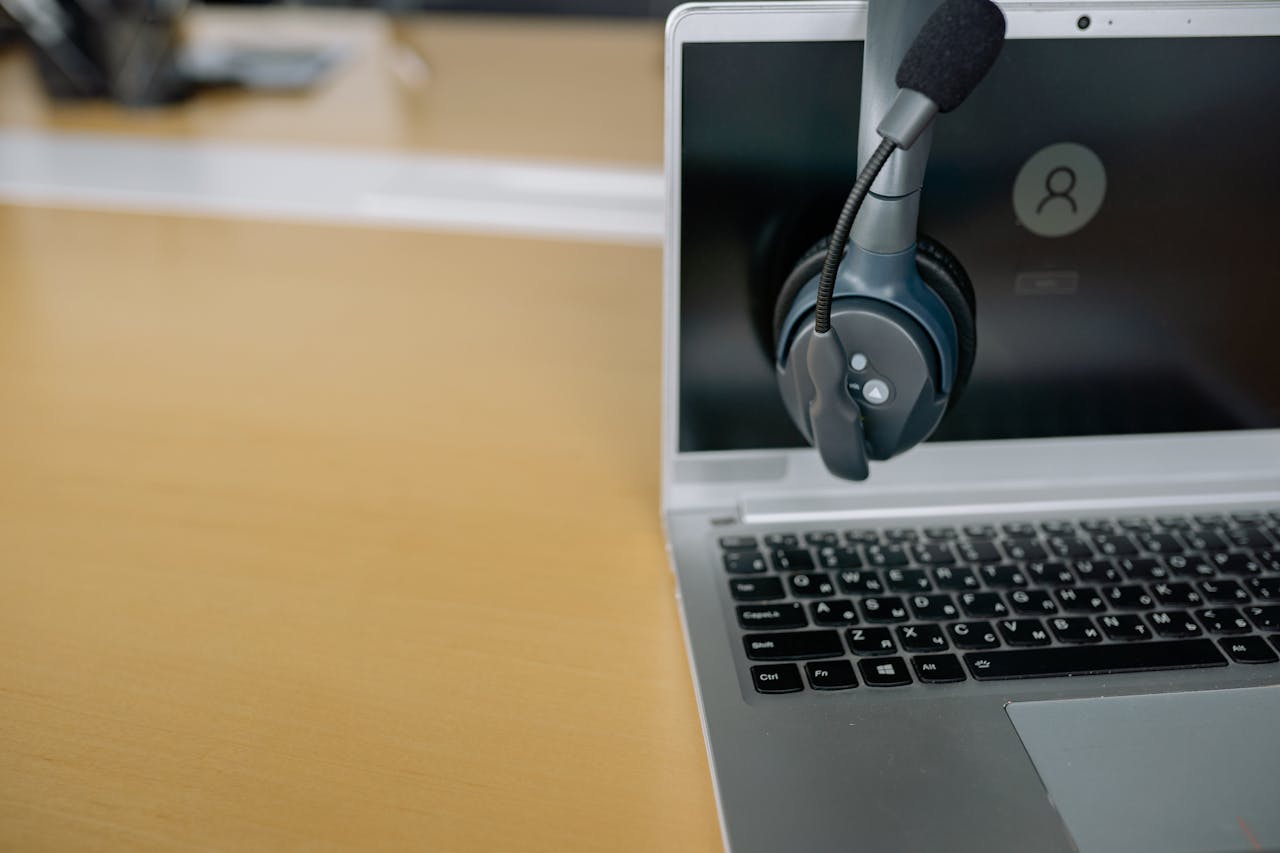 journey Close-up of wireless headset on laptop screen, ideal for communication tech visuals.